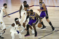 Los Angeles Lakers forward LeBron James (23) is defended by Indiana Pacers guard Malcolm Brogdon (7) during the third quarter of an NBA basketball game Saturday, Aug. 8, 2020, in Lake Buena Vista, Fla. (Kim Klement/Pool Photo via AP)