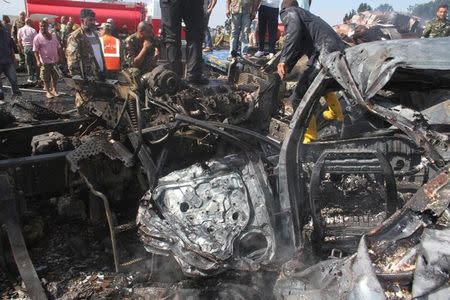 Syrian army soldiers inspect the damage as civil defense members work at the site of two explosions that hit the Arzouna bridge area at the entrance to Tartous, Syria in this handout picture provided by SANA on September 5, 2016. SANA/Handout via REUTERS