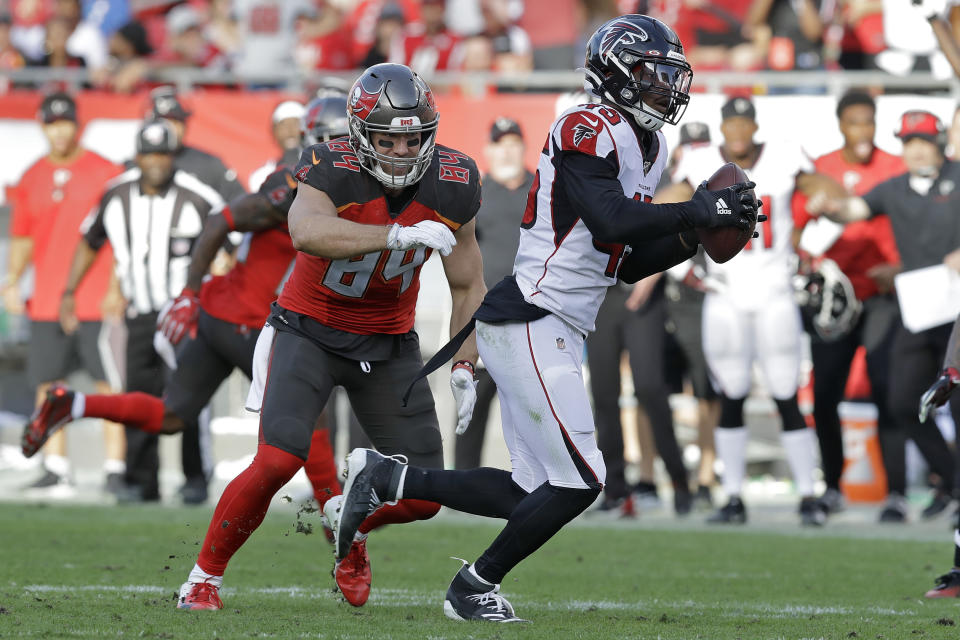 Atlanta Falcons linebacker Deion Jones (45) intercepts a pass by Tampa Bay Buccaneers quarterback Jameis Winston intended for tight end Cameron Brate (84) and returns it for the game-winning touchdown during the overtime of an NFL football game Sunday, Dec. 29, 2019, in Tampa, Fla. (AP Photo/Chris O'Meara)