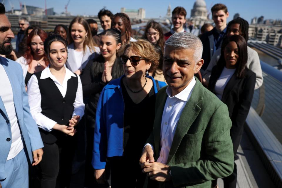Sadiq Khan and his wife Saadiya stand with supporters on the Millennium Bridge (REUTERS)
