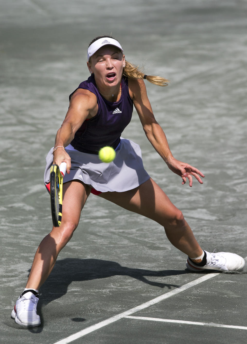 Caroline Wozniacki reaches for a shot from Mihaela Buzarnescu at the Volvo Car Open tennis tournament Thursday, April 4, 2019, in Charleston, S.C. (Grace Beahm Alford/The Post And Courier via AP)