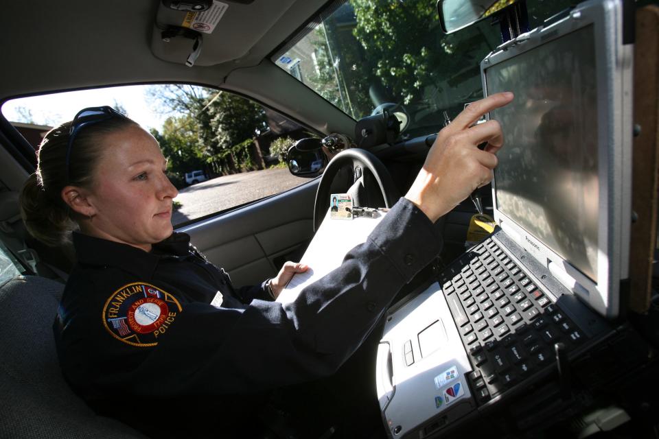 Franklin police officer Leigh Ann Hester checks a motorist's license and registration during a traffic stop while on patrol in 2008. Hester is the first woman since World War II to be awarded a Silver Star for valor while serving in Iraq.