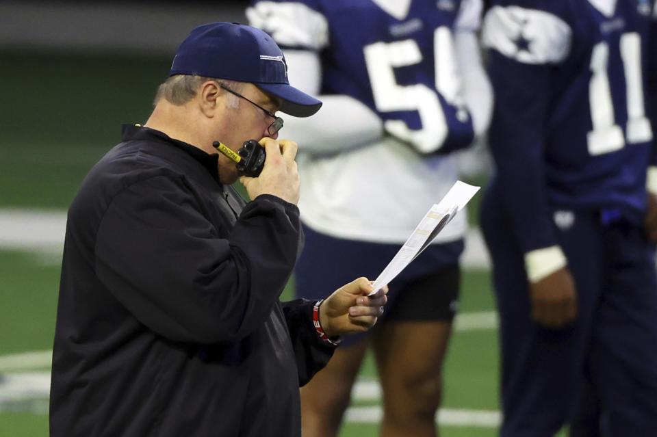Dallas Cowboys head coach Mike McCarthy talks on a walkie talkie during an NFL football practice, Tuesday, June 6, 2023, in Frisco, Texas. (AP Photo/Richard W. Rodriguez)