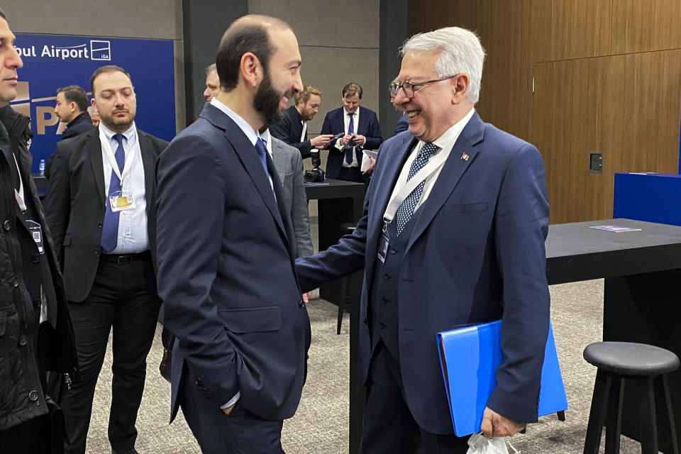 Armenia's Foreign Minister Ararat Mirzoyan, left, talks to Serdar Kilic, Turkey's special envoy for negotiations with Armenia, ahead of a meeting with his Turkish counterpart Mevlut Cavusoglu on the sidelines of the Antalya Diplomacy Forum in Antalya, Turkey, Saturday, March 12, 2022. Turkey and Armenia, which have no diplomatic ties, are engaged in talks aimed at ending decades of bitter relations between their two nations. (AP Photo/Suzan Fraser)