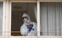 FILE PHOTO: FILE PHOTO: A sanitary worker cleans the nursing home where a woman died and several residents and care providers have been diagnosed with coronavirus disease (COVID-19) in Grado