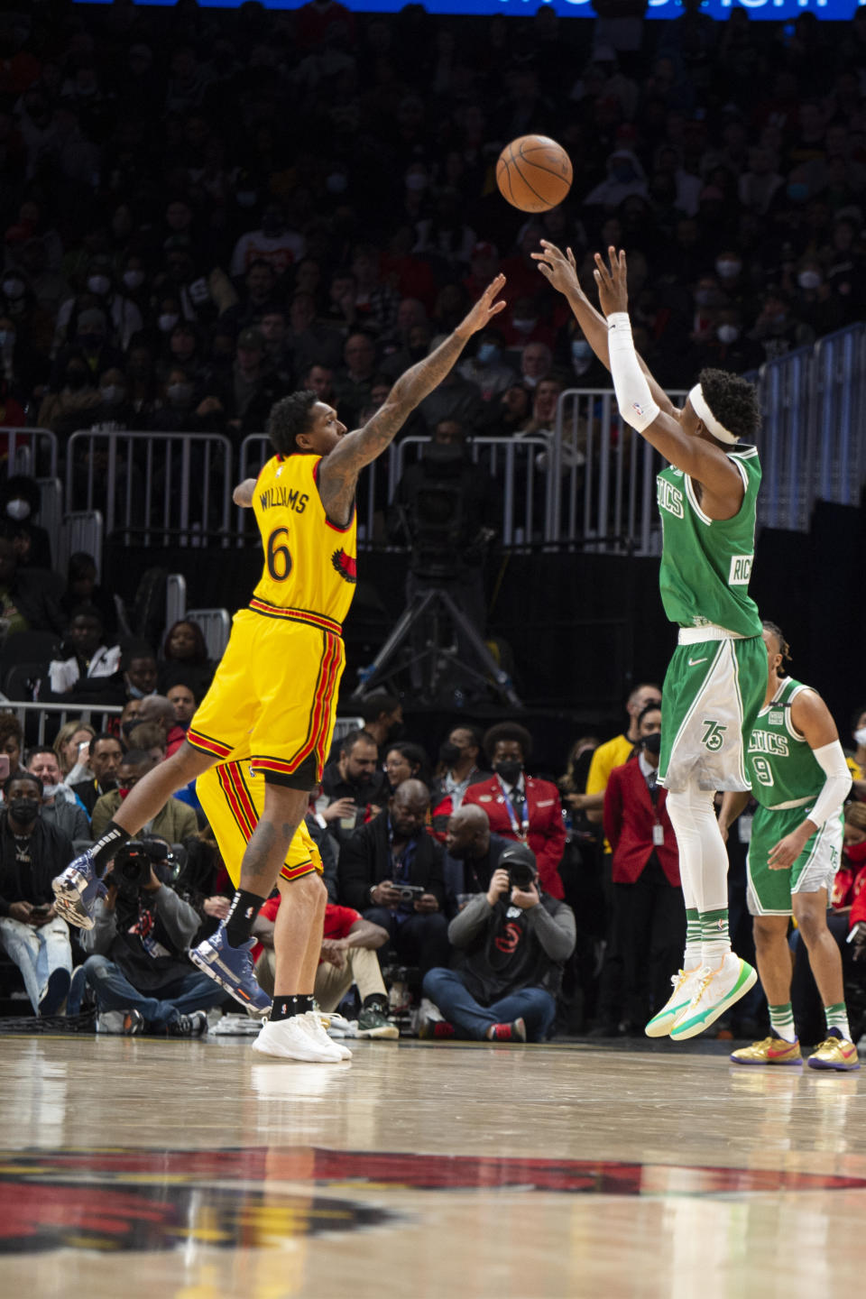 Boston Celtics guard Josh Richardson, right, shoots a three-point basket over Atlanta Hawks guard Lou Williams (6) during the second half of an NBA basketball game Friday, Jan. 28, 2022, in Atlanta. (AP Photo/Hakim Wright Sr.)