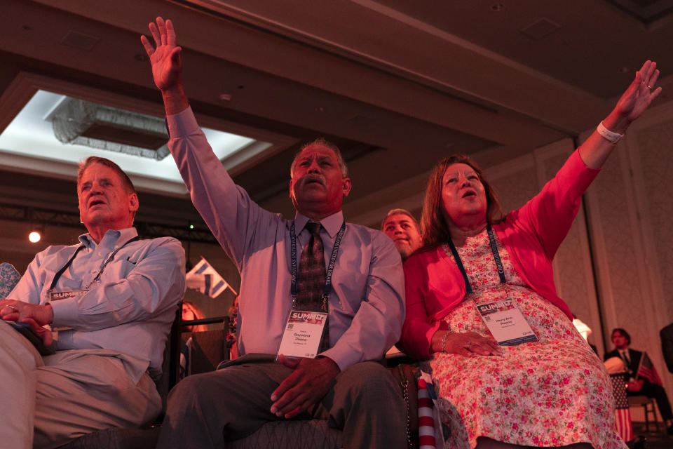 A crowd made of mostly of Evangelical Christians pray during the Christians United For Israel (CUFI) "Night to Honor Israel" during the CUFI Summit 2023, Monday, July 17, 2023, in Arlington, Va., at the Crystal Gateway Marriott. (AP Photo/Jacquelyn Martin)