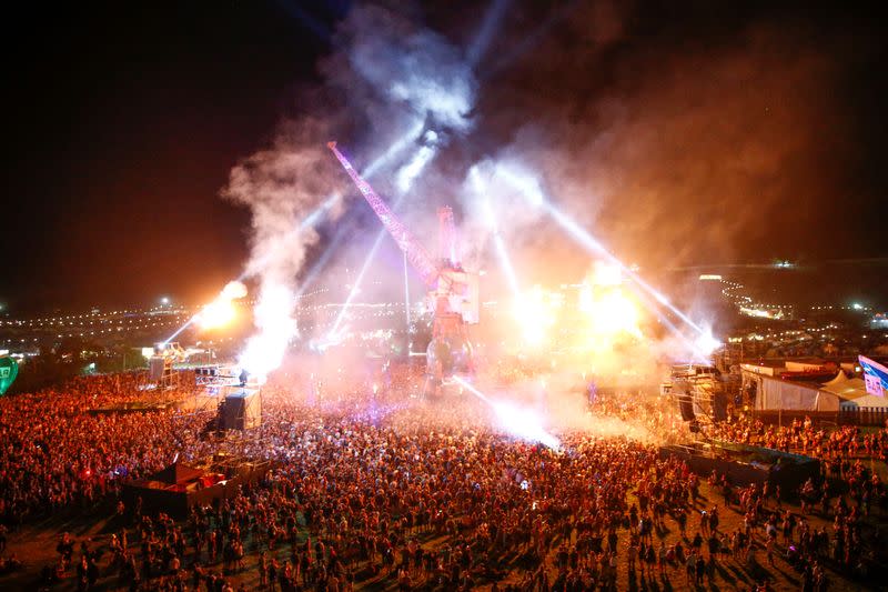 FILE PHOTO: Festival goers in the late night Arcadia area during Glastonbury Festival in Somerset