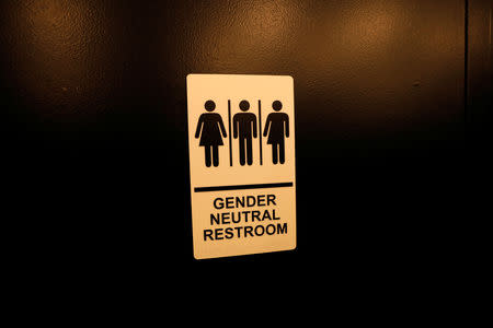 FILE PHOTO - A sign is seen on a gender neutral restroom wall in New York City, U.S., April 19, 2017. REUTERS/Mike Segar
