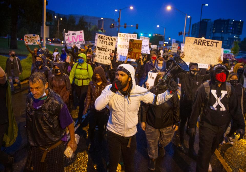 Midas Well, center, leads a group of demonstrators in a march through the streets of Eugene Sept. 23, 2020 in protest of the Breonna Taylor decision in Louisville, Ky.