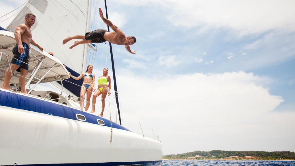 man jumping off boat into water