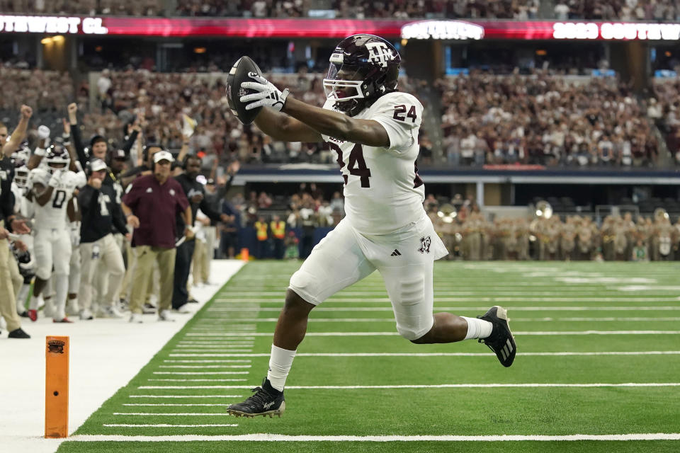 Texas A&M running back Earnest Crownover (24) runs for a touchdown during the first half of an NCAA college football game against Arkansas Saturday, Sept. 30, 2023, in Arlington, Texas. (AP Photo/LM Otero)