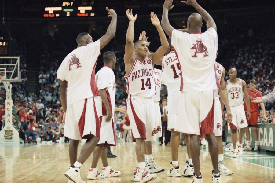 Arkansas players, including Corey Beck (14), celebrate their 91-82 victory over Arizona in their Final Four semifinal game on Saturday, April 2, 1994, in Charlotte, N.C. Arkansas advances to Mondays championship game. (AP Photo/Bob Jordan)