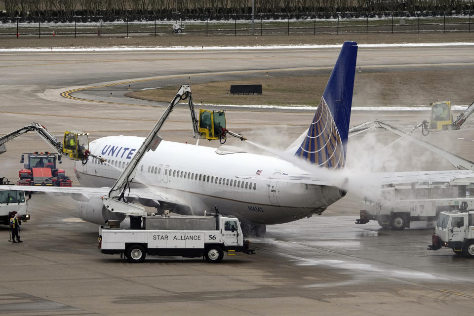 A United Airlines jet is deiced at George Bush Intercontinental Airport Tuesday, Feb. 16, 2021, in Houston. Airport officials said crews are still working to clear thick patches of ice off of the airfield. They expect the airfield to open later this evening after being closed for days due to the severe cold weather which blanketed the area with snow and ice. (AP Photo/David J. Phillip)