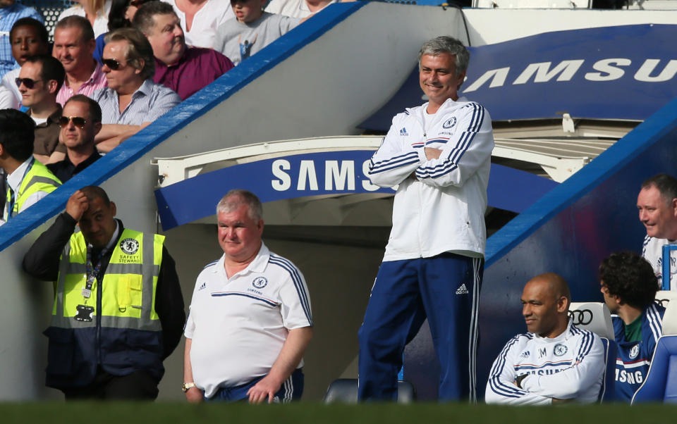 Chelsea manager Jose Mourinho smiles as he watches their English Premier League soccer match against Norwich City at Stamford Bridge stadium in London, Sunday May 4, 2014. (AP Photo/Alastair Grant)