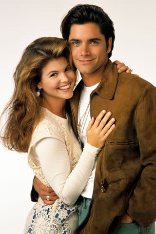 <p>Bob D'Amico /Disney General Entertainment Content via Getty</p> Lori Loughlin and John Stamos on 'Full House' in 1993