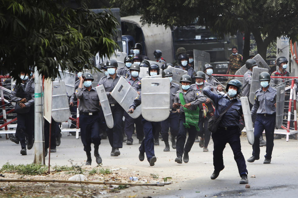 FILE - In this Feb. 20, 2021, file photo, police charge forward to disperse protesters in Mandalay, Myanmar. The military takeover of Myanmar early in the morning of Feb. 1 reversed the country's slow climb toward democracy after five decades of army rule. But Myanmar's citizens were not shy about demanding their democracy be restored. (AP Photos)