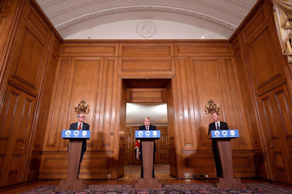 Britain's Prime Minister Boris Johnson (C), Britain's Chief Medical Officer for England Chris Whitty (R) and Britain's Chief Scientific Adviser Patrick Vallance attend a virtual press conference inside 10 Downing Street in central London on December 19, 2020. - British Prime Minister Boris Johnson on Saturday announced a 