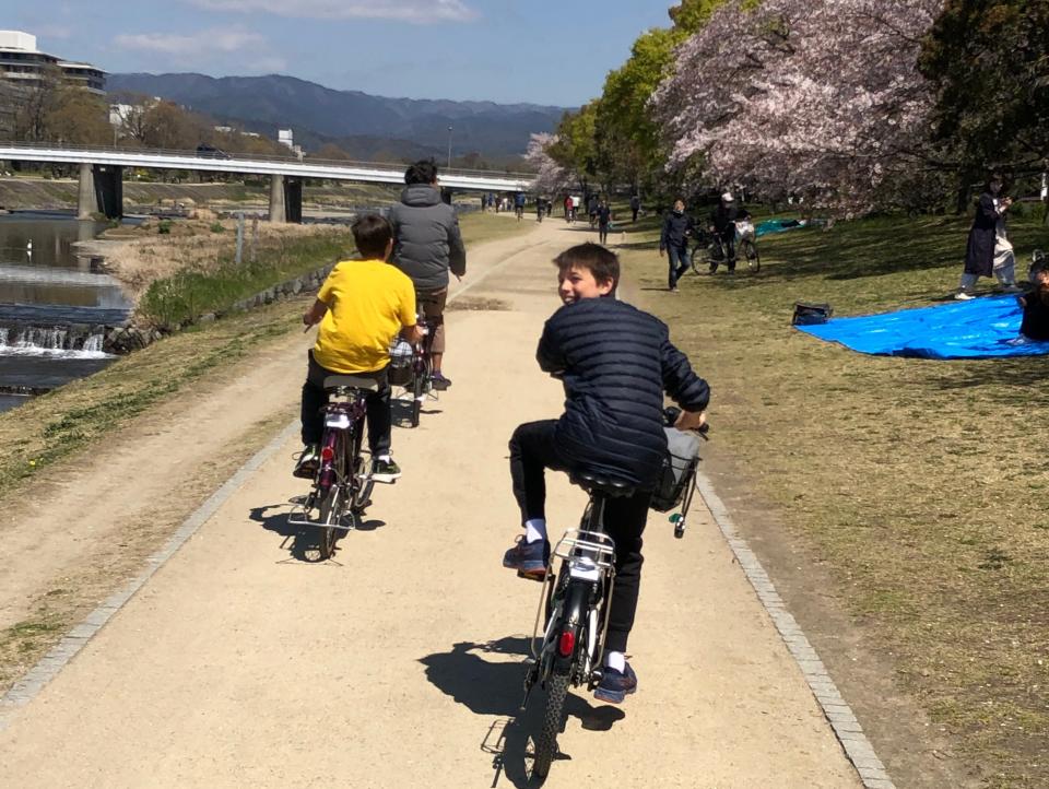 A group of people on bikes with one person looking back at the camera.