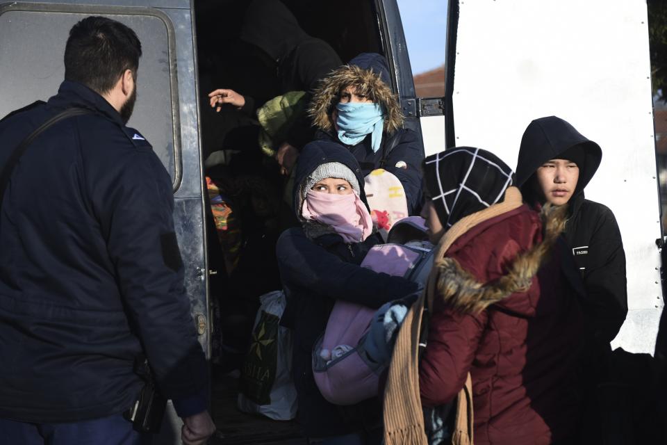 Migrants detain by Greek authorities in the village of Thourio near the Greek-Turkish border on Sunday, March 1, 2020. Turkey's President Recep Tayyip Erdogan said his country's borders with Europe were open Saturday, making good on a longstanding threat to let refugees into the continent as thousands of migrants gathered at the frontier with Greece. (AP Photo/Giannis Papanikos)