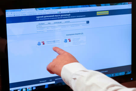 Yegor Sobolev, a lawmaker and the head of the Ukrainian parliament's committee on fighting corruption, points to a computer screen showing the online income declaration system during an interview with Reuters in Kiev, Ukraine, October 17, 2016. REUTERS/Valentyn Ogirenko