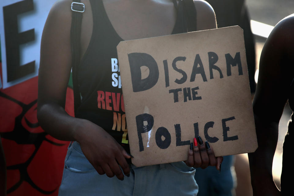 <p>Demonstrators march through the South Shore neighborhood protesting the shooting death of 37-year-old Harith Augustus on July 16, 2018 in Chicago, Ill. (Photo: Scott Olson/Getty Images) </p>