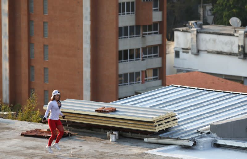 A woman jumps rope at a rooftop during a nationwide quarantine due to the coronavirus disease (COVID-19) outbreak in Caracas