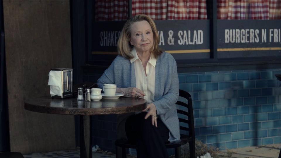 Debra Jo Rupp's Sharon Davis having coffee at table outside of restuarant