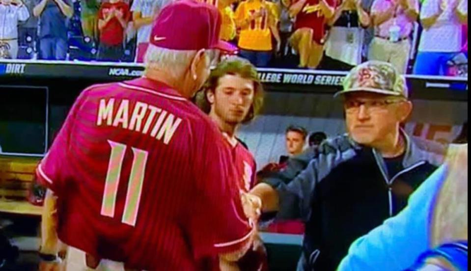 Chip Baker and Mike Martin shake hands following Martin's final game in a Seminoles uniform at the 2019 College World Series.