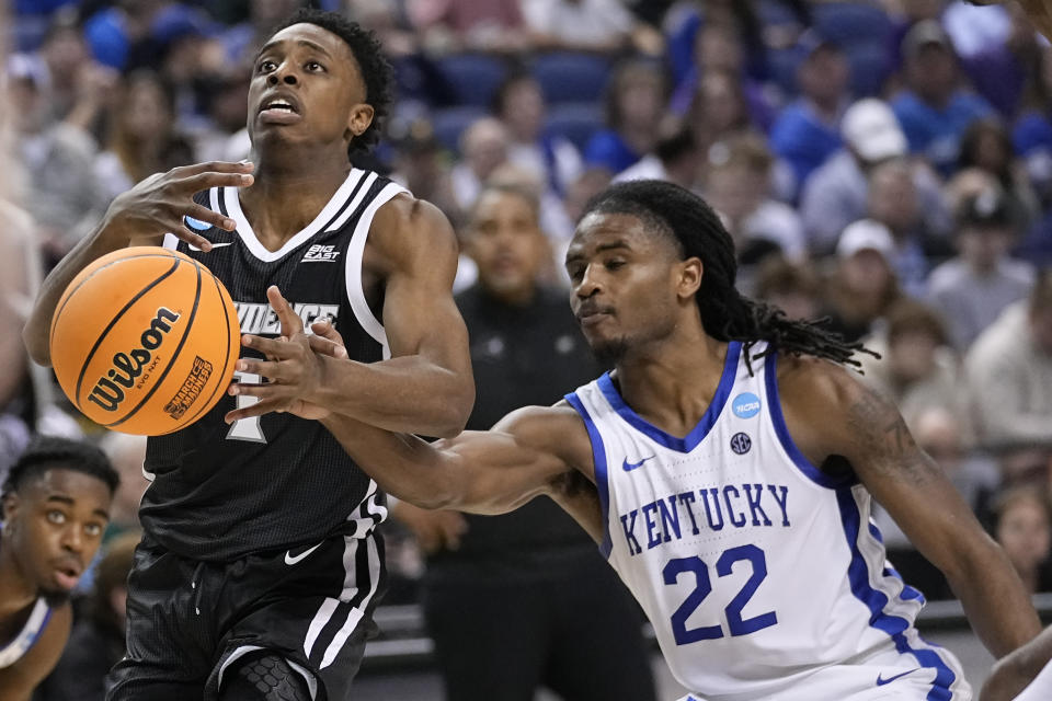 Kentucky guard Cason Wallace (22) tries to knock the ball away from Providence guard Jayden Pierre (1) during the second half of a first-round college basketball game in the NCAA Tournament on Friday, March 17, 2023, in Greensboro, N.C. (AP Photo/John Bazemore)