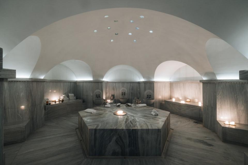 Candlelit and hushed, the marble-clad Byzantine hammam room provides a luxurious setting for exfoliation and massage. Stavros Habakis, Visual-Storyteller