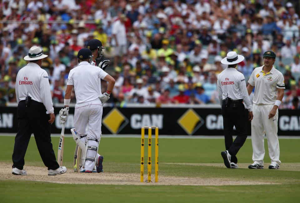 Australia's Shane Watson (R) tries to say something to England's Joe Root and Kevin Pietersen (2nd L) as Sri Lanka's umpire Kumar Dharmasena intervenes during the fourth day's play in the second Ashes cricket test at the Adelaide Oval December 8, 2013.