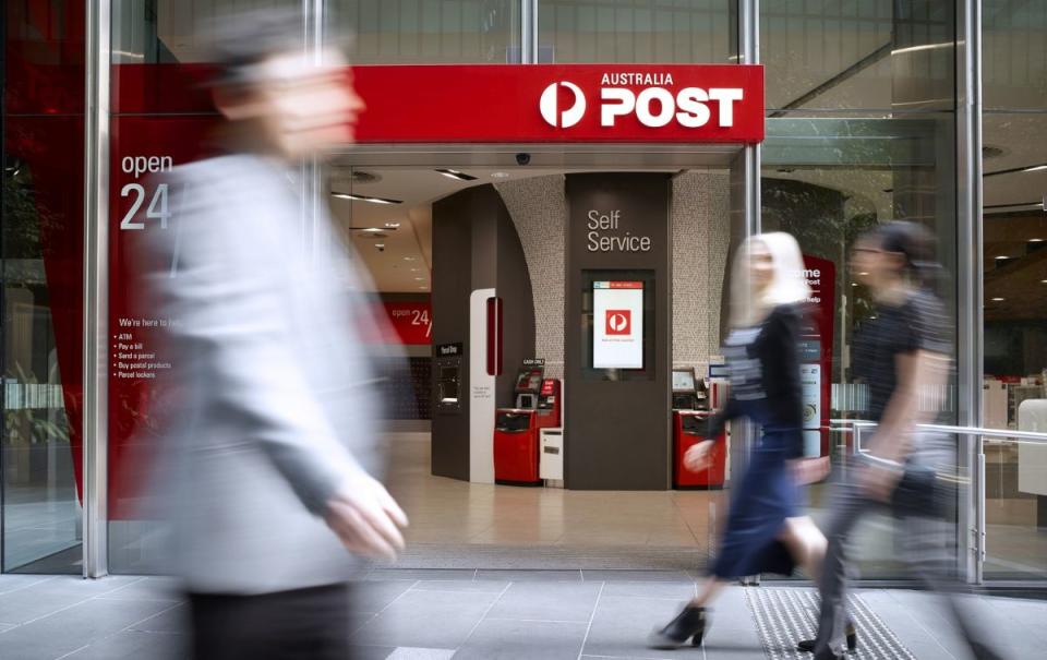 An Australia Post centre in Sydney as people walk past not in focus. 