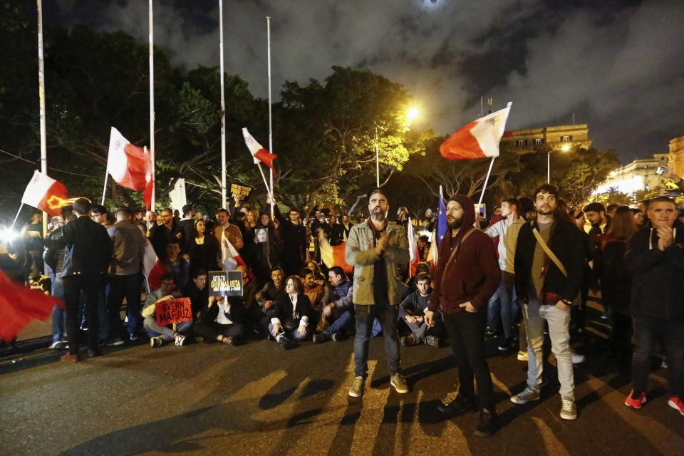 People stage a protest in La Valletta, Malta, Sunday, Dec. 1, 2019. Malta's embattled prime minister has received a pledge of confidence from Labor Party lawmakers amid demands for his resignation by citizens angry over alleged links of his former top aide to the car bomb killing of a Maltese anti-corruption journalist. Hours later, thousands of Maltese protested outside a courthouse demanding that Joseph Muscat step down. (AP Photo)