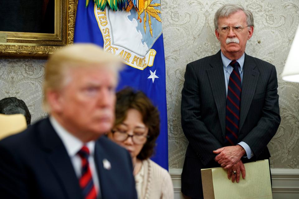 Then-national security adviser John Bolton observes President Donald Trump in 2018.
