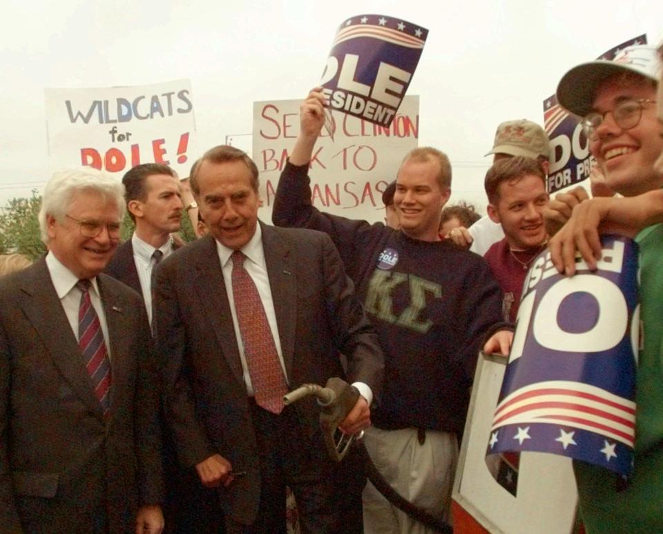 Republican presidential hopeful Bob Dole holds a gas nozzle and says 