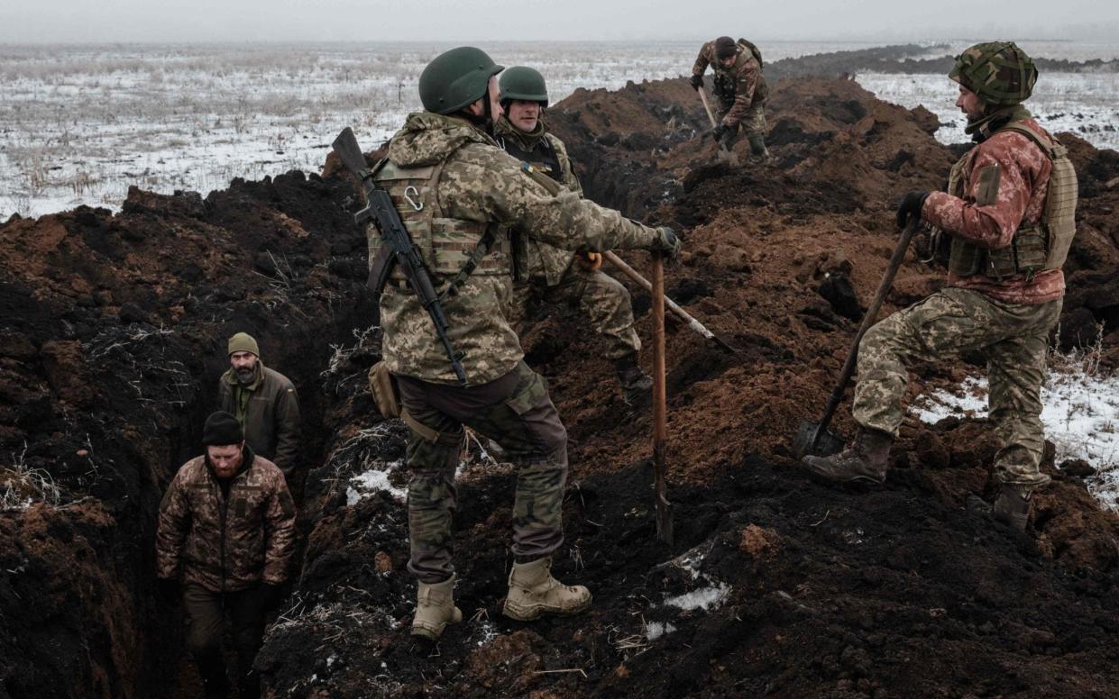 Ukrainian soldiers digging a trench in Bakhmut, as they brace for a Russian spring offensive - Yasuyoshi Chiba/AFP via Getty Images