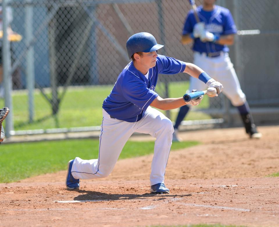 St. Martin's Matthew Schlangen puts down a sacrifice bunt as St. Martin defeated Cold Spring 9-1 at Cold Spring Baseball Park on Saturday, Aug. 14, 2021. 