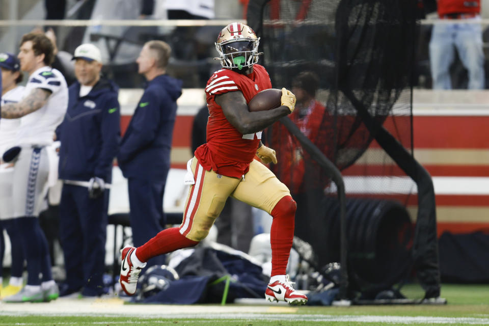 San Francisco 49ers wide receiver Deebo Samuel (19) runs toward the end zone to score during the second half of an NFL wild card playoff football game against the Seattle Seahawks in Santa Clara, Calif., Saturday, Jan. 14, 2023. (AP Photo/Jed Jacobsohn)
