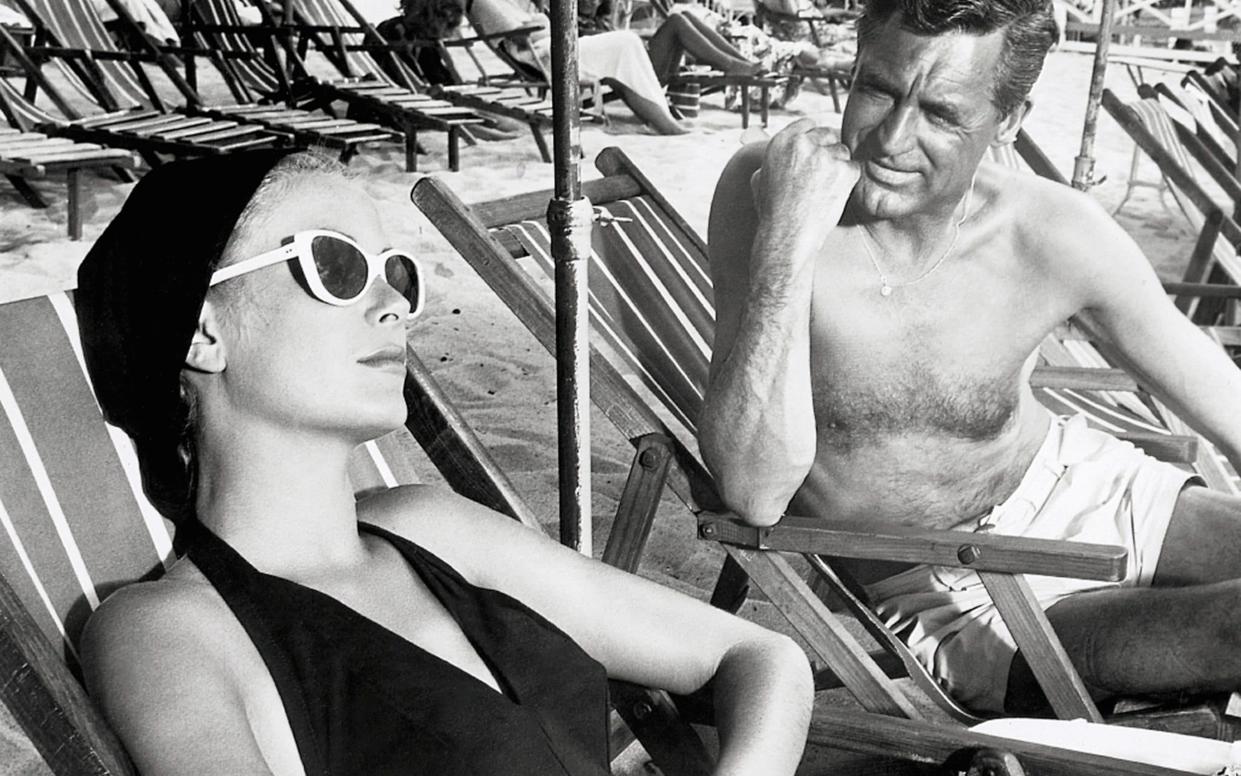 Cary Grant and Kelly lounging on the beach in a scene from the 1955 classic 'To Catch a Thief'