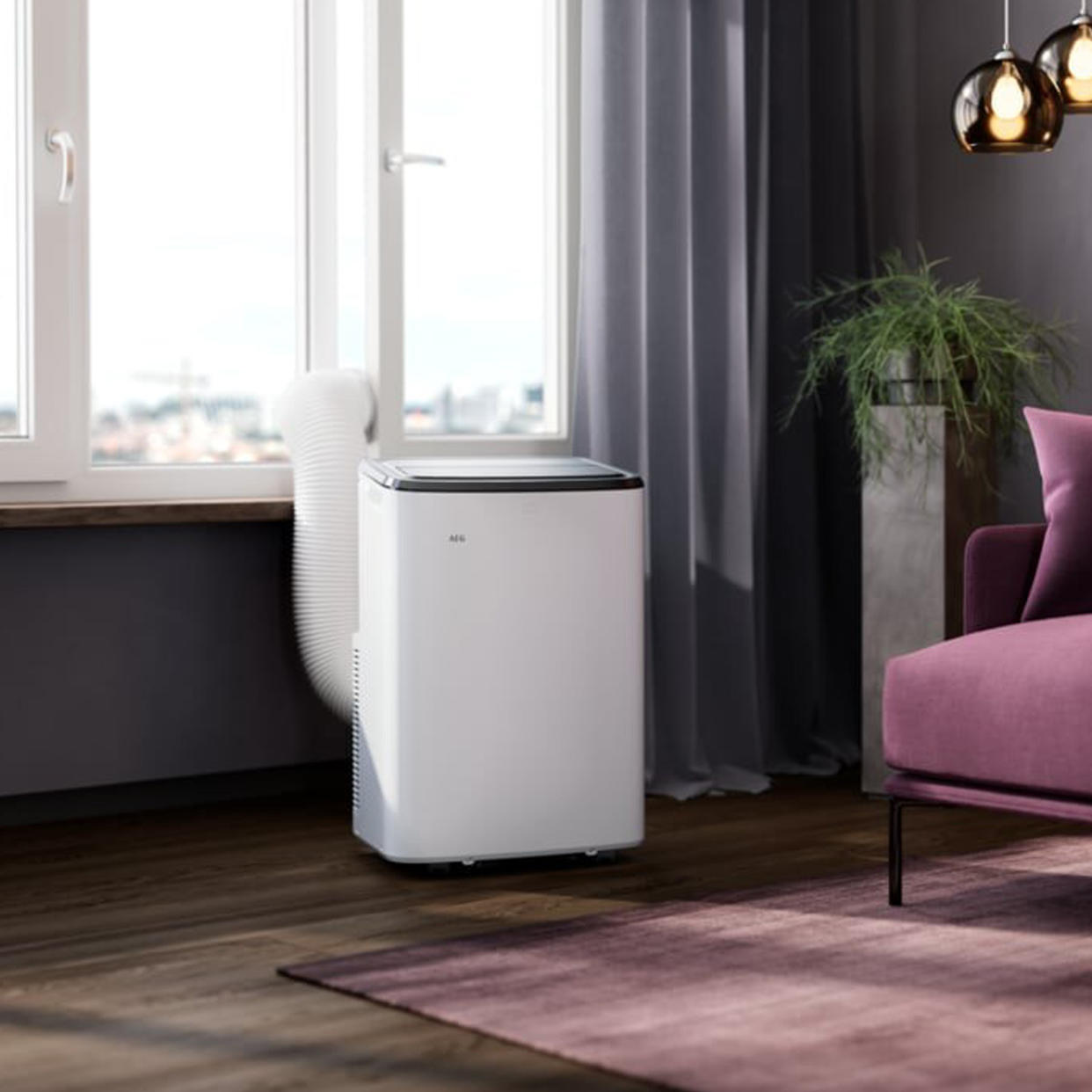  The white AEG Comfort 6000 Portable Air Conditioner in a room with purple furnishings 