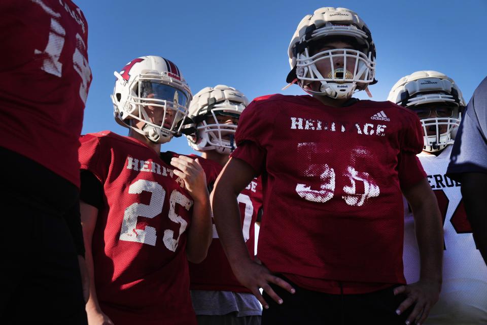 Heritage Academy players huddle up before calling a play during practice in Laveen, Ariz. on Wednesday, Oct. 26, 2022.