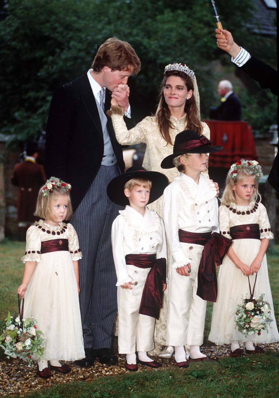 GREAT BRINGTON, UNITED KINGDOM - SEPTEMBER 16:  Viscount Althorp (charles Spencer) Kissing The Hand Of Bride, Victoria Lockwood. Bridesmaids And Pageboys (l To R)  Eleanor Fellowes, Prince Harry, Alexander Fellowes  Emily Mccorquodale.wedding Outfit By Tomasz Starzewski  (Photo by Tim Graham Photo Library via Getty Images)