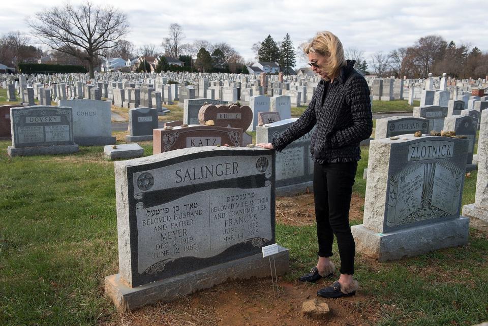 Ashley Govberg of Villanova visits the grave of her grandmother, Frances Salinger, following the unveiling of her headstone at Montefiore Cemetery Tuesday, Nov. 27, 2018 in Abington. After Salinger's death in 2015 her remains were unclaimed until Montgomery County Deputy Coroner Alex Balacki tracked Govberg down. She had been estranged from her grandmother following her father's passing. [BILL FRASER / STAFF PHOTOJOURNALIST]