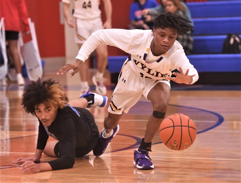 Wylie's Jaden Torres, right, chases after a loose ball while a North Crowley player looks on. The Panthers beat Wylie 67-34 in the pool opener at the Raising Cane's Key City Classic on Thursday at Cougar Gym.