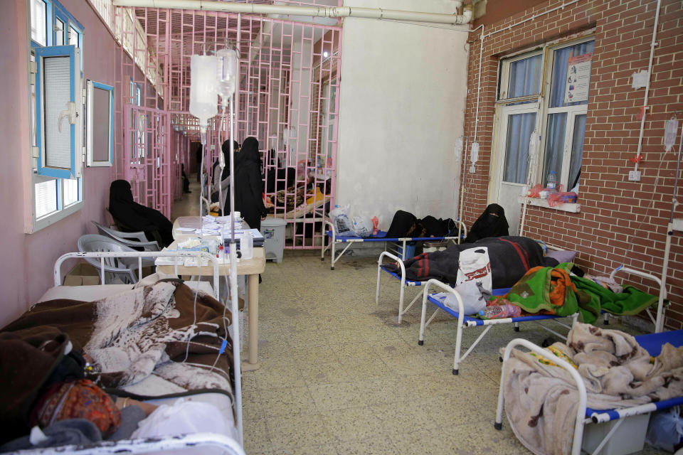 FILE - In this March 30, 2019 file photo, women are treated for suspected cholera infection at Al-Sabeen hospital, in Sanaa, Yemen. An Associated Press investigation found some of the United Nations aid workers sent in to Yemen amid a humanitarian crisis caused by five years of civil war have been accused of enriching themselves from an outpouring of donated food, medicine and money. Documents from an internal probe of the U.N.’s World Health Organization uncovered allegations of large funds deposited in staffers’ personal bank accounts, suspicious contracts, and tons of donated medicine diverted or unaccounted for. (AP Photo/Hani Mohammed, File)
