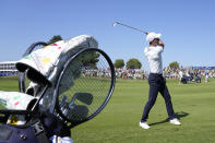 World number 1 tennis player player Novak Djokovic hits a shot from the 1st fairway, with his golf bag containing two tennis rackets, during an all stars golf match between Team Colin Montgomerie and Team Cory Pavin at the Marco Simone Golf Club in Guidonia Montecelio, Italy, Wednesday, Sept. 27, 2023. The Ryder Cup starts Sept. 29, at the Marco Simone Golf Club. (AP Photo/Andrew Medichini)