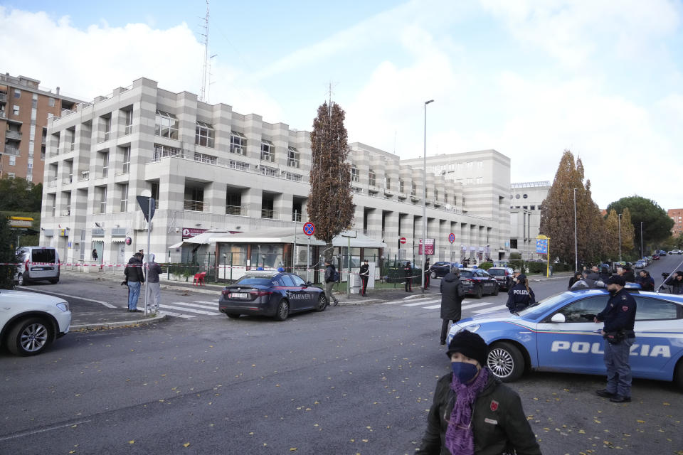 Italian Carabinieri, paramilitary policemen, patrol in front of a bar where three people died after a man entered and shot in Rome, Sunday, Dec. 11, 2022. (AP Photo/Gregorio Borgia)