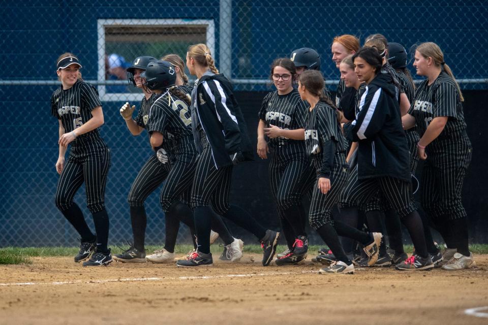 The Jasper Wildcats gather at home plate after Jasper’s Brianna Barrix (24) hits a home run as the Jasper Wildcats play the Memorial Tigers in Evansville, Ind., Tuesday, April 23, 2024.