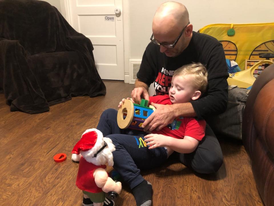Four-year-old Davis Cameron playing with his father Terry Graham. Cameron is unable to attend school all day because there are not enough educational assistants to take care of him.
